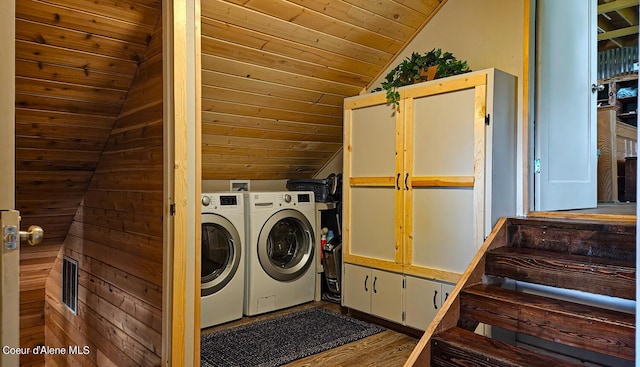 laundry area with wood ceiling, laundry area, visible vents, washing machine and dryer, and wood finished floors