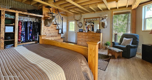 bedroom featuring multiple windows and wood finished floors