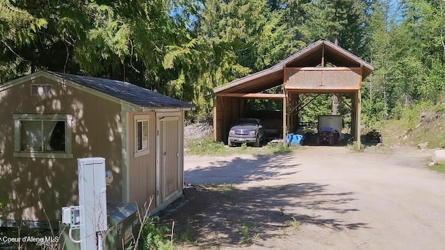 view of parking with driveway and a carport