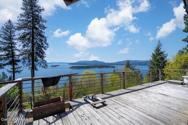 wooden deck featuring a water and mountain view