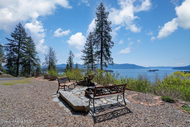 view of yard featuring a patio area and a water and mountain view