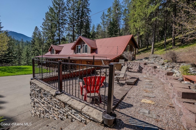 2264 Parker Canyon Rd, Bonners Ferry, ID 83805 - exterior space with a patio, a wooded view, and metal roof