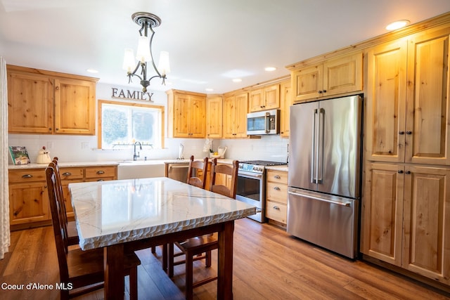 2264 Parker Canyon Rd, Bonners Ferry, ID 83805 - kitchen with backsplash, stainless steel appliances, a notable chandelier, and a sink