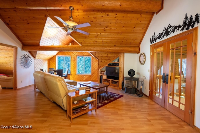 2264 Parker Canyon Rd, Bonners Ferry, ID 83805 - living room featuring light wood-style flooring, lofted ceiling with beams, french doors, and a wood stove