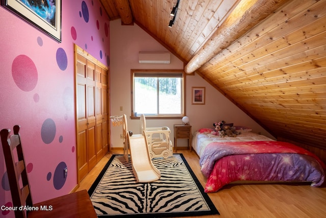 2264 Parker Canyon Rd, Bonners Ferry, ID 83805 - bedroom featuring vaulted ceiling with beams, a wall unit AC, wooden ceiling, rail lighting, and light wood finished floors
