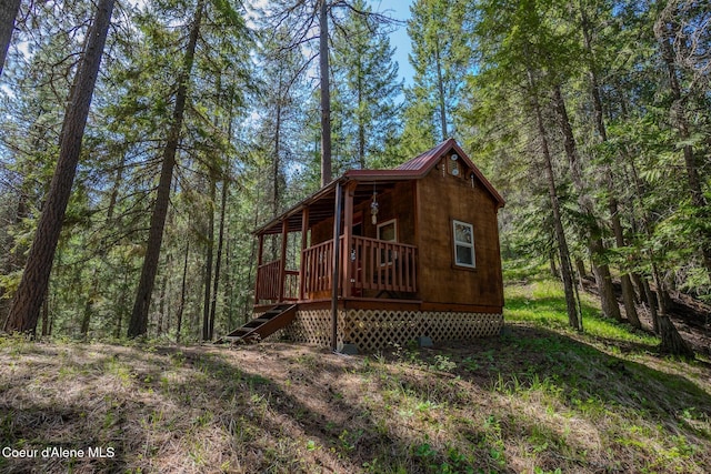 2264 Parker Canyon Rd, Bonners Ferry, ID 83805 - exterior space featuring a view of trees, metal roof, and stairway