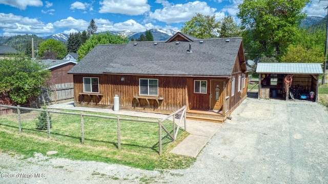 chalet / cabin with a shingled roof and a mountain view