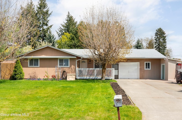2450 N Ridgeview Dr, Post Falls, ID 83854 - ranch-style home with an attached garage, a front lawn, a porch, and concrete driveway