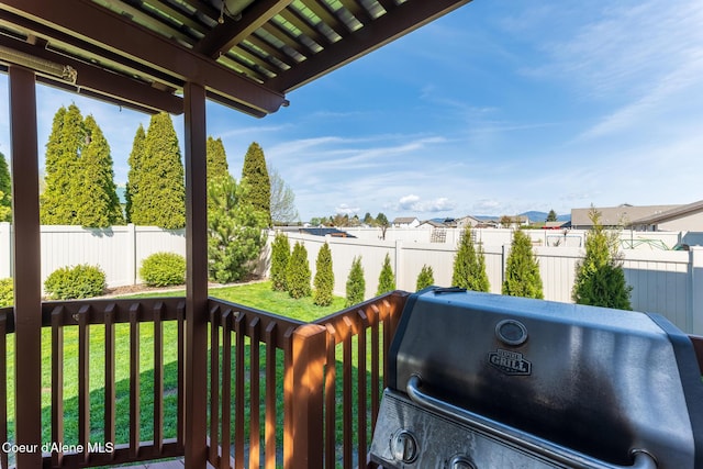 exterior space featuring a lawn, a residential view, a fenced backyard, and area for grilling