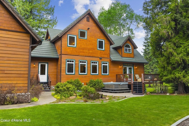 1201 Paradise Valley Rd, Bonners Ferry, ID 83805 - back of property with a hot tub, a deck, a lawn, and french doors