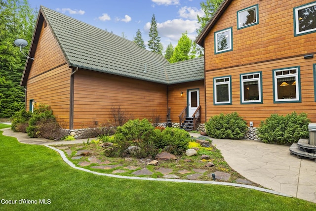 1201 Paradise Valley Rd, Bonners Ferry, ID 83805 - back of house featuring entry steps, a yard, and a patio