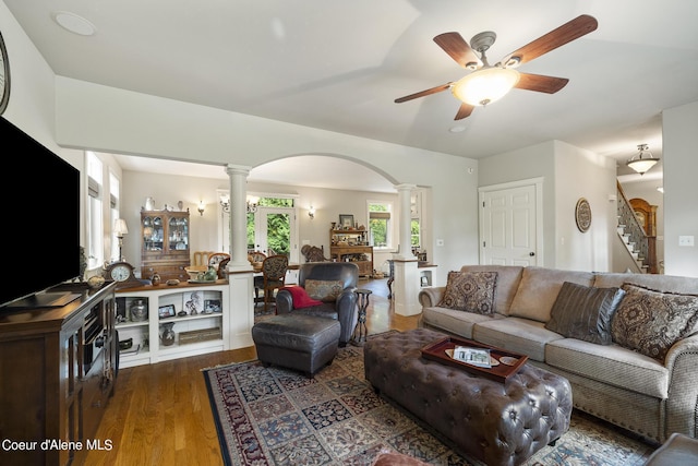 1201 Paradise Valley Rd, Bonners Ferry, ID 83805 - living area featuring decorative columns, wood finished floors, arched walkways, a ceiling fan, and stairway