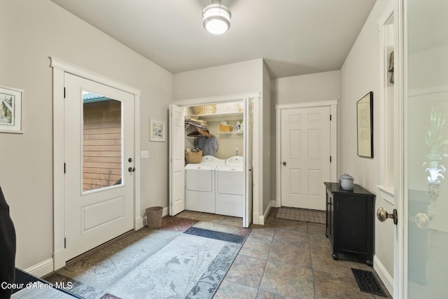 1201 Paradise Valley Rd, Bonners Ferry, ID 83805 - entrance foyer featuring separate washer and dryer, baseboards, and stone finish floors
