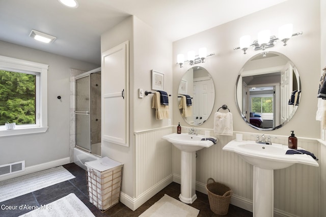1201 Paradise Valley Rd, Bonners Ferry, ID 83805 - bathroom with a wainscoted wall, tile patterned flooring, shower / bath combination with glass door, and a sink