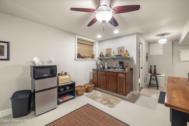 1201 Paradise Valley Rd, Bonners Ferry, ID 83805 - kitchen featuring black microwave, fridge, brown cabinets, a sink, and ceiling fan