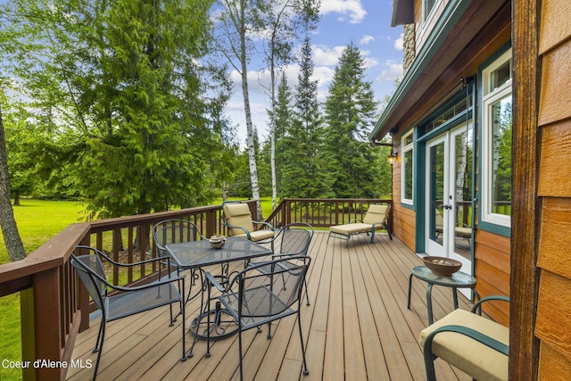 1201 Paradise Valley Rd, Bonners Ferry, ID 83805 - deck featuring outdoor dining space, french doors, and view of wooded area