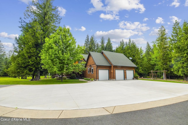 1201 Paradise Valley Rd, Bonners Ferry, ID 83805 - view of home's exterior with concrete driveway, a lawn, and a garage