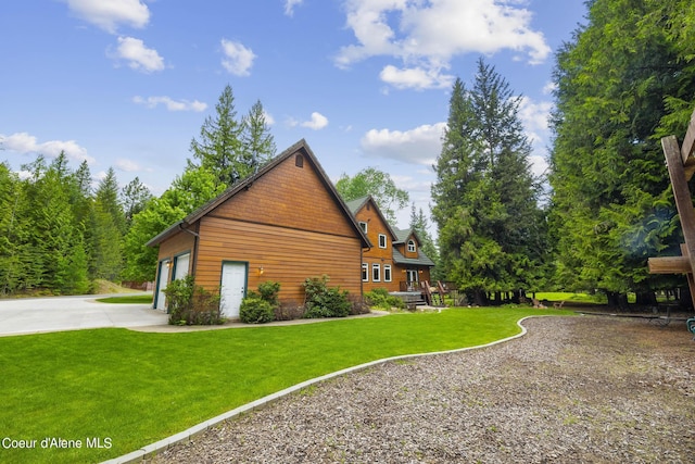 1201 Paradise Valley Rd, Bonners Ferry, ID 83805 - view of property exterior with driveway, a lawn, and an attached garage