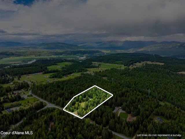 1201 Paradise Valley Rd, Bonners Ferry, ID 83805 - aerial overview of property's location featuring mountains, a heavily wooded area, and property boundaries highlighted