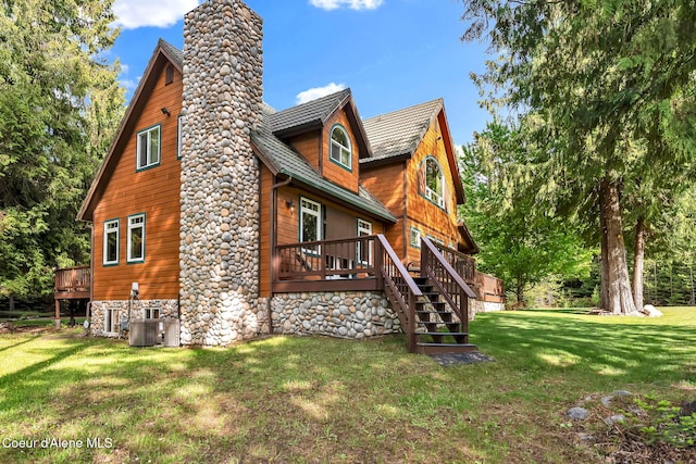 1201 Paradise Valley Rd, Bonners Ferry, ID 83805 - back of property featuring a chimney, a deck, a lawn, and stairs