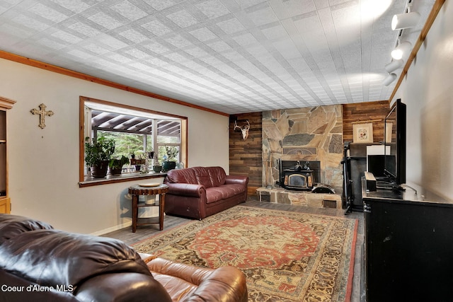 19856 B St Joe River Rd, Calder, ID 83808 - living room featuring wood walls, ornamental molding, wood finished floors, and a wood stove