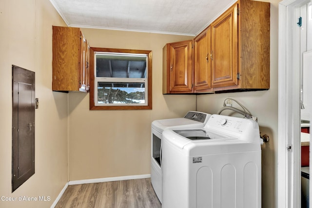19856 B St Joe River Rd, Calder, ID 83808 - laundry area featuring electric panel, washing machine and clothes dryer, light wood-type flooring, cabinet space, and baseboards