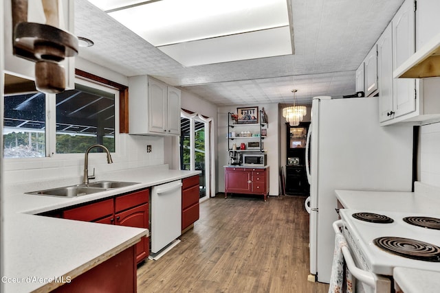 19856 B St Joe River Rd, Calder, ID 83808 - kitchen with white dishwasher, a sink, light wood-style floors, light countertops, and stainless steel microwave