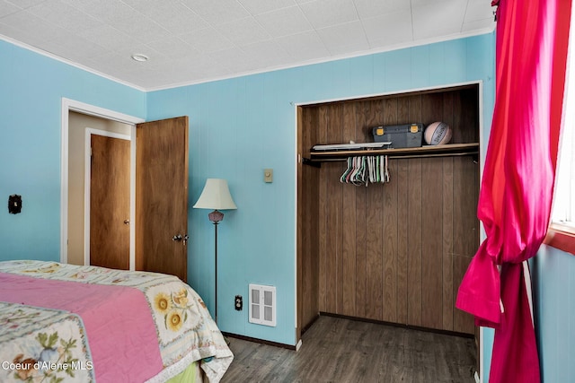 19856 B St Joe River Rd, Calder, ID 83808 - bedroom featuring crown molding, wood walls, a closet, wood finished floors, and baseboards