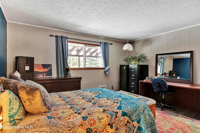 19856 B St Joe River Rd, Calder, ID 83808 - bedroom with visible vents, a textured ceiling, wood finished floors, and wooden walls