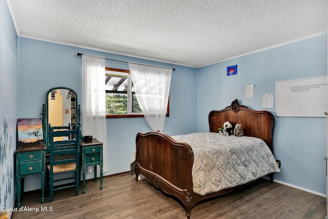 19856 B St Joe River Rd, Calder, ID 83808 - bedroom with crown molding, a textured ceiling, and wood finished floors
