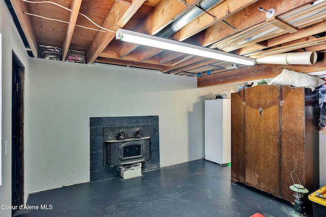 19856 B St Joe River Rd, Calder, ID 83808 - unfinished below grade area featuring white fridge and a wood stove