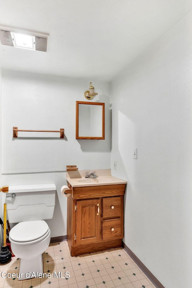 19856 B St Joe River Rd, Calder, ID 83808 - bathroom featuring baseboards, vanity, toilet, and visible vents