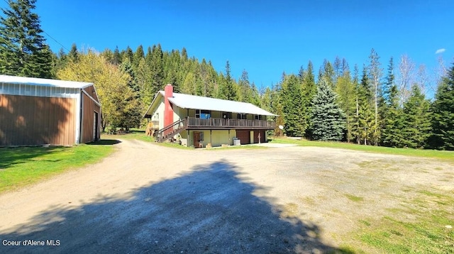 19856 B St Joe River Rd, Calder, ID 83808 - log home featuring an outdoor structure, a chimney, stairs, driveway, and a forest view