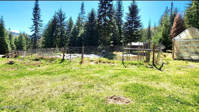 19856 B St Joe River Rd, Calder, ID 83808 - view of yard featuring an exterior structure, fence, an outbuilding, and a forest view
