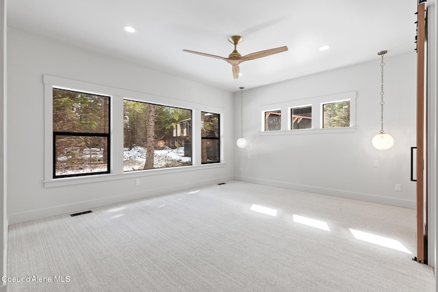 carpeted empty room featuring visible vents, a ceiling fan, baseboards, and recessed lighting