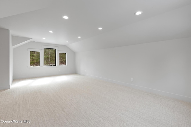 bonus room featuring baseboards, lofted ceiling, recessed lighting, and light colored carpet