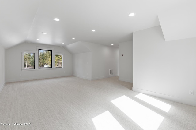 bonus room featuring recessed lighting, lofted ceiling, visible vents, and light carpet