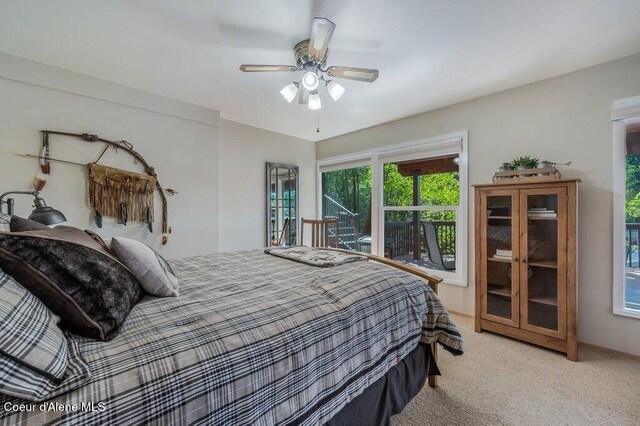 bedroom with a ceiling fan and light carpet
