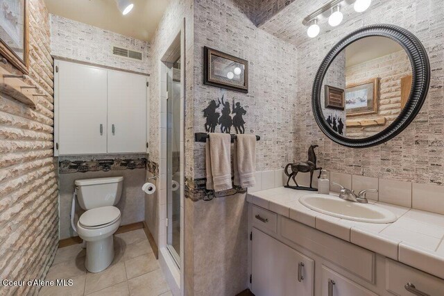 bathroom with visible vents, a stall shower, tile patterned floors, vanity, and toilet