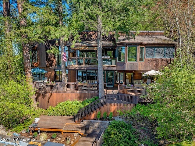 back of house with a wooden deck, stairway, and a balcony