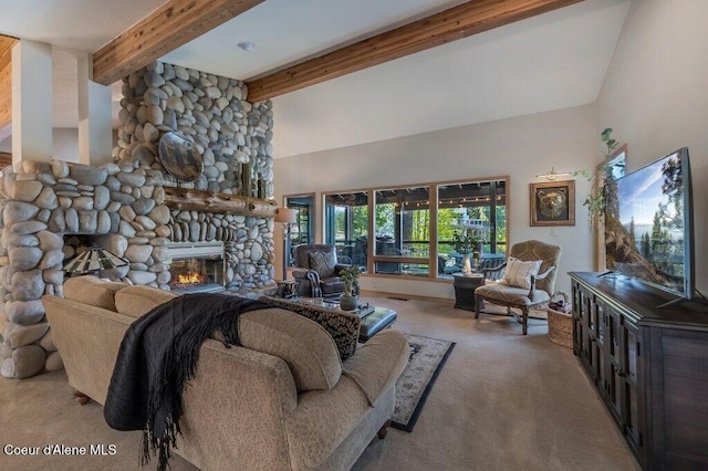 carpeted living room featuring a high ceiling, beam ceiling, and a stone fireplace