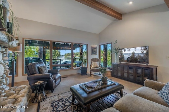 carpeted living area with beam ceiling and high vaulted ceiling