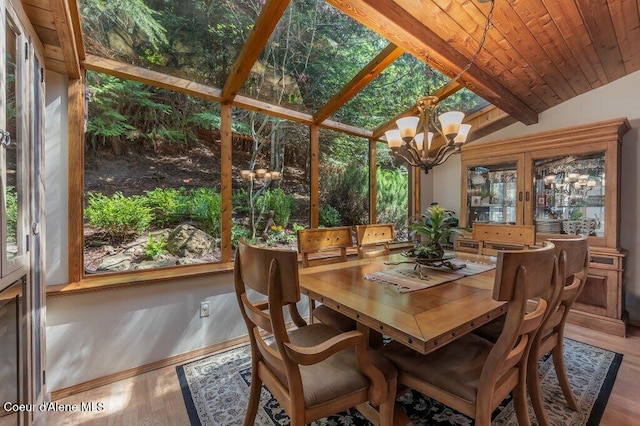 sunroom with beamed ceiling, french doors, and a chandelier