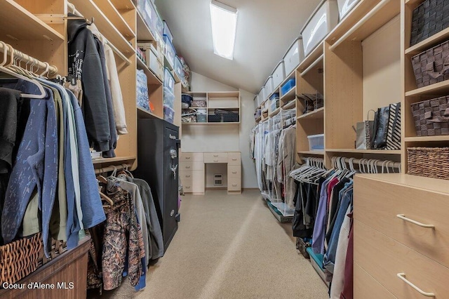 walk in closet featuring vaulted ceiling and carpet flooring