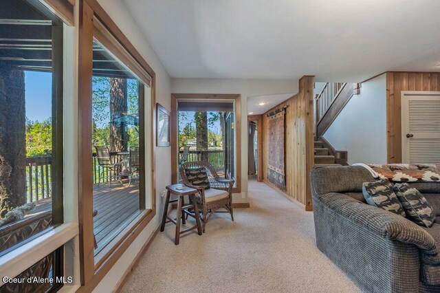 living room with light colored carpet and stairs