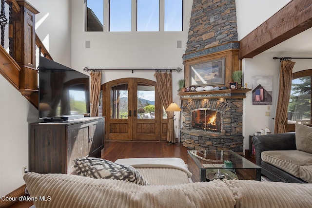 6012 W Quartzite Ln, Coeur Dalene, ID 83814 - living area with a fireplace, a towering ceiling, dark wood-style flooring, and french doors