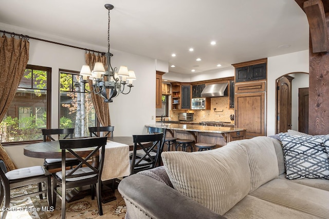 6012 W Quartzite Ln, Coeur Dalene, ID 83814 - dining space with a chandelier, arched walkways, and recessed lighting