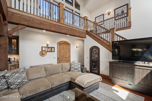 6012 W Quartzite Ln, Coeur Dalene, ID 83814 - living room with arched walkways, a high ceiling, wood finished floors, and baseboards