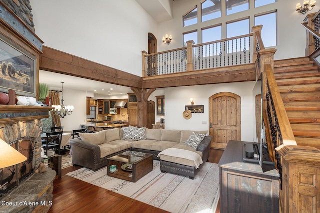6012 W Quartzite Ln, Coeur Dalene, ID 83814 - living room with a high ceiling, hardwood / wood-style flooring, stairs, and a chandelier