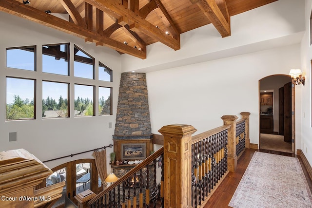 6012 W Quartzite Ln, Coeur Dalene, ID 83814 - hall featuring wood ceiling, high vaulted ceiling, beamed ceiling, dark wood finished floors, and arched walkways